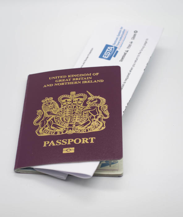 <p>A UK passport with an ESTA form on a white background.</p>

<p>Find more photos like this on my website.</p>
UK passport with an ESTA form