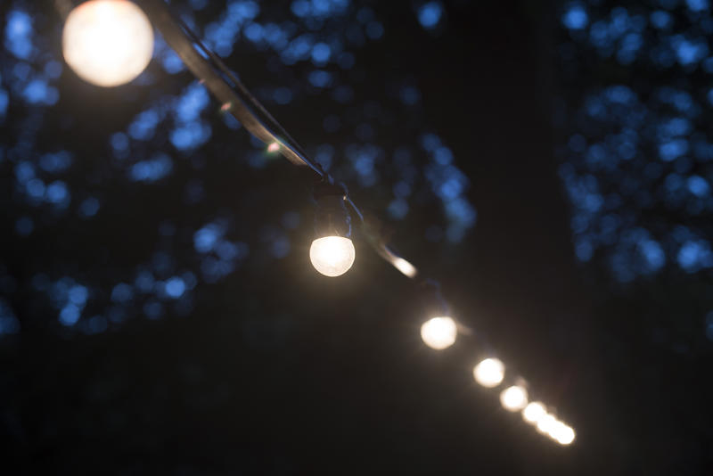 a line of glowing outdoor lights with warm white bulbs