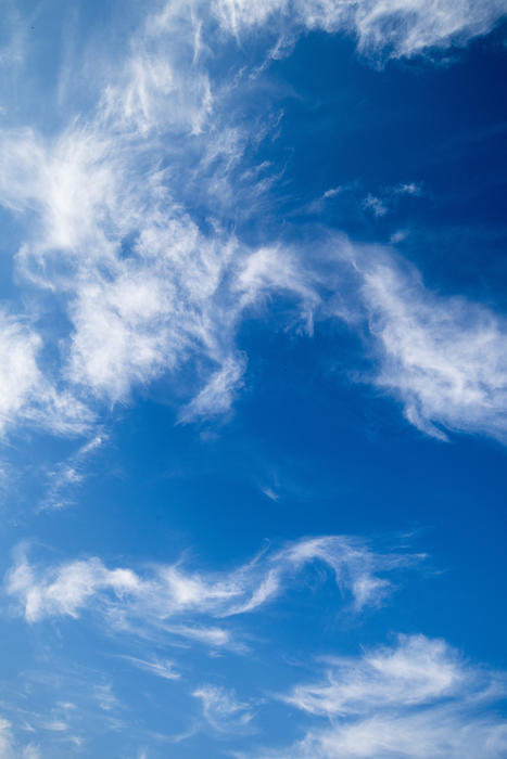 a blue sky with swirling layers of cirrus clouds