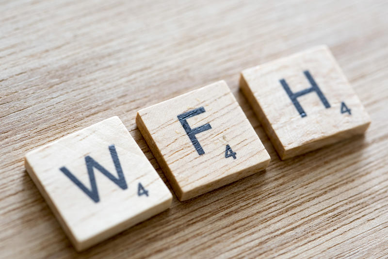 WFH, or Work From Home, letters on wooden blocks from a word game conceptual of telecommuting during the coronavirus pandemic