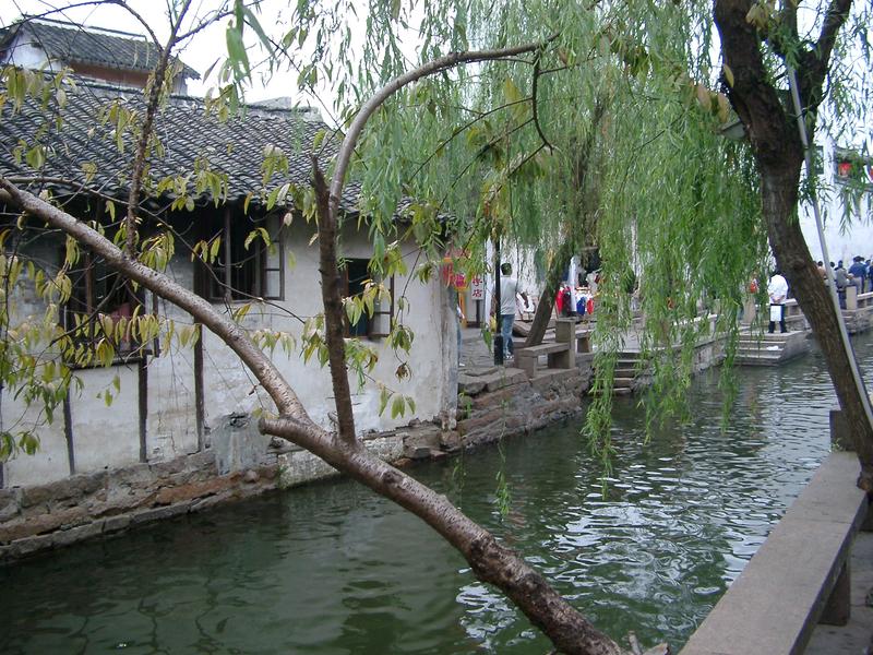 a canal running through a small town in china