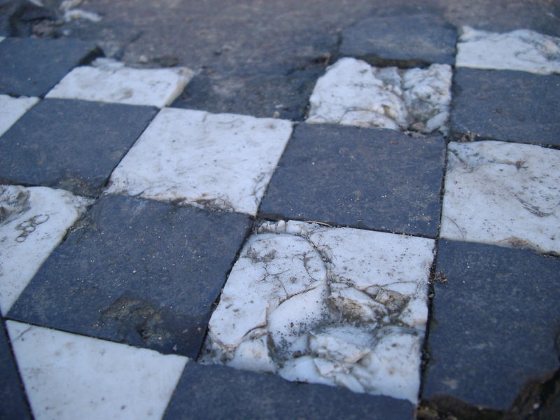 checked tile floor damaged remains of a runied building