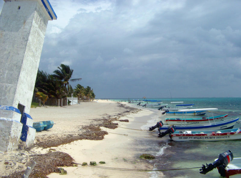 beach and fishing boats at Puerto Morelos, Quintana Roo, Mexico