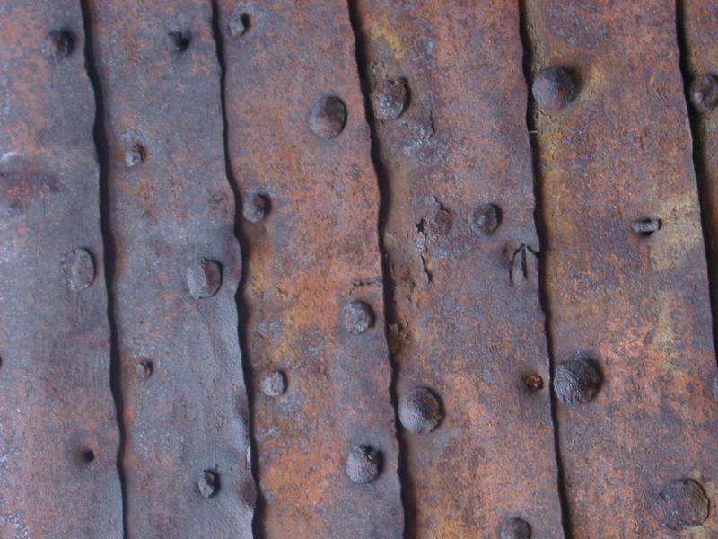grunge background of rusted metal sheets and old rivets
