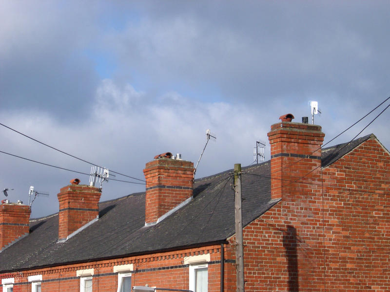 terrace house rooftops and chimneys on a row of british houses