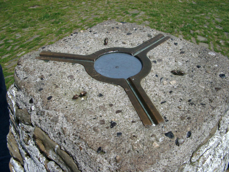 an ordinance survey triangulation marker on top of a mountain, concept of hiking, trecking, orienteering and navigaton