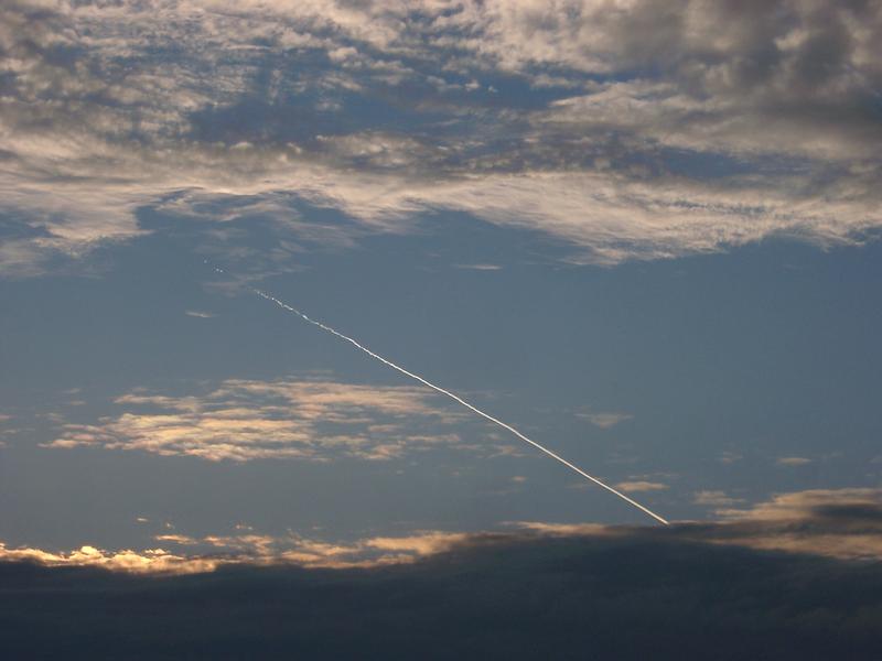 clouds and sky with a vapour trail from a passing jet aircraft