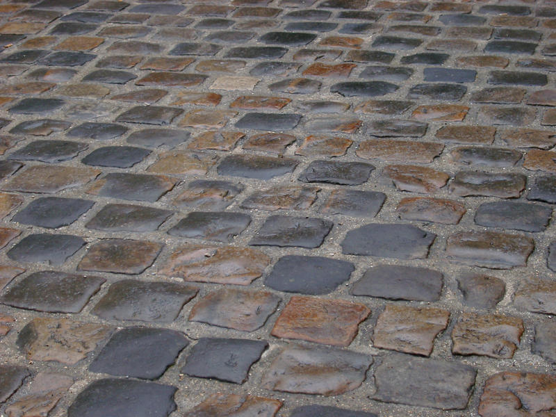 a road surface of wet cobble stones