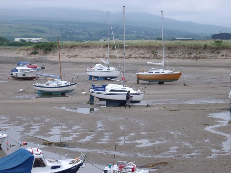 a tidal harbour full of yachts at low tide
