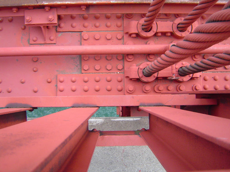 close up on the red painted structure of the golden gate bridge, san francisco