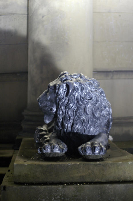 a lion statue looking away from the camera