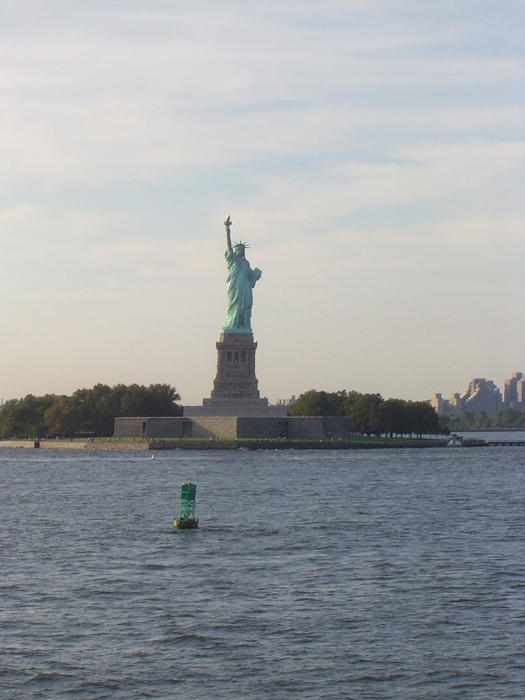 Liberty Enlightening the World standing proud at the gateway to new york city