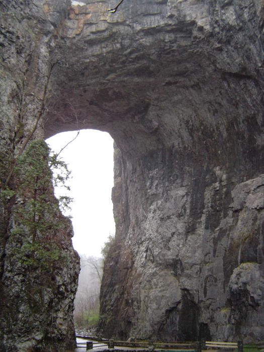 a rock arch in a sheer cliff face