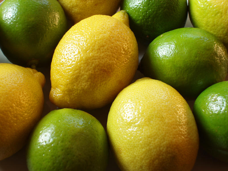 a bowl of limes and lemons