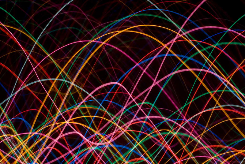 waving colourful lines of light on a black background