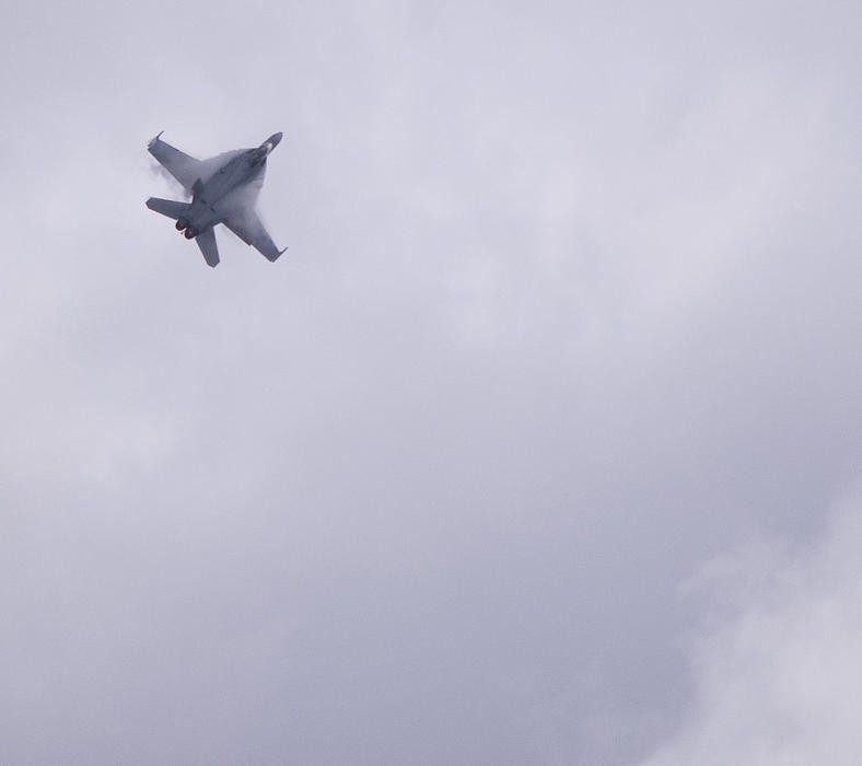 Clouds of vapour forming on the wings and leading flight surfaces of an FA18 Super Hornet