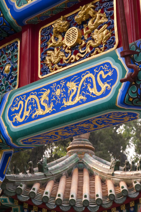 close up on the lucky gold decorations and paintings on a traditional chinese temple archway