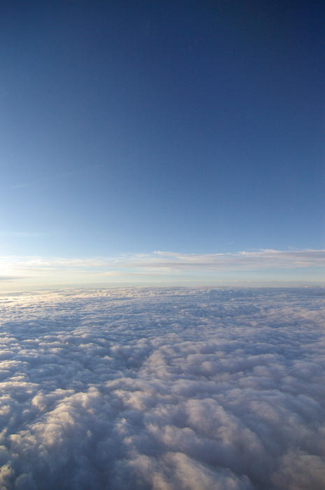a view of clouds below from a high altitude aircraft