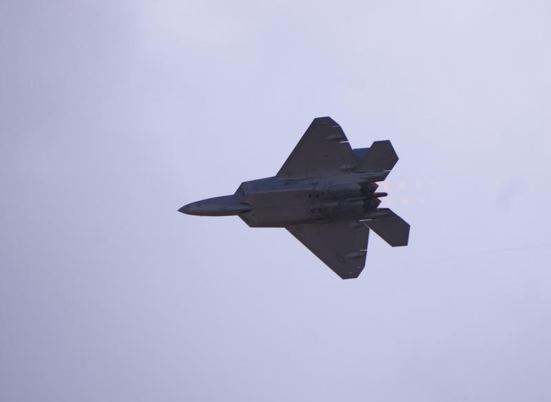 A bottom view of a F-22 Raptor as it flys overhead