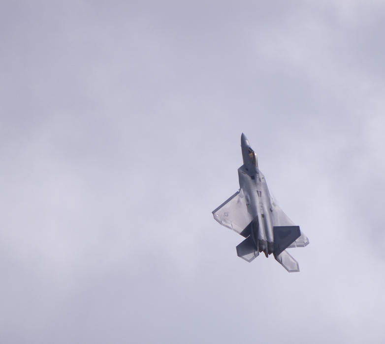 an F-22 Raptor Stealth Fighter in a steep climb