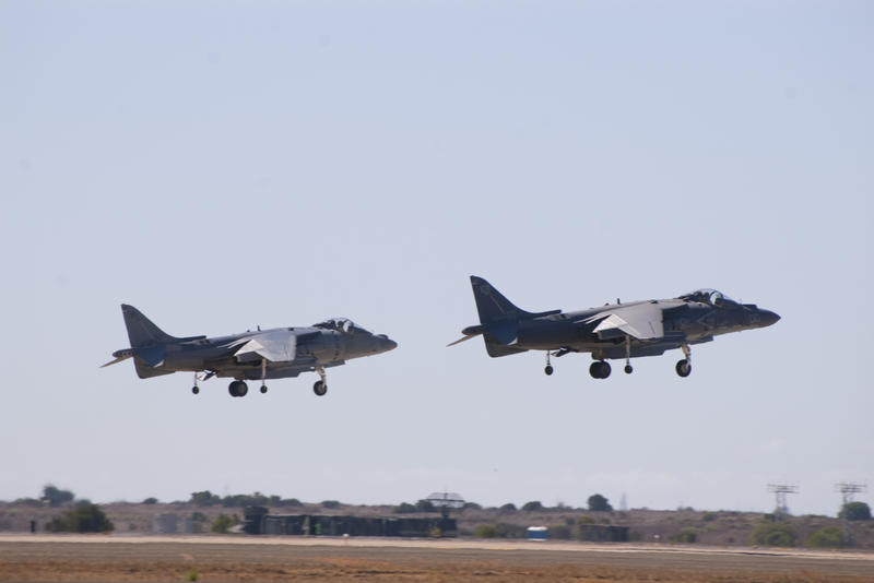 Two harrier aircraft performng vertical landing