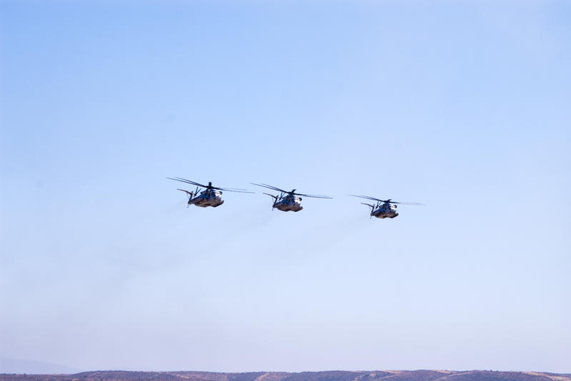 three heavily armoured CH-53e Super Stallion helicopters flying in formation