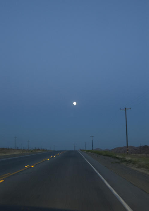driving into a moonlit night on california's highway 1