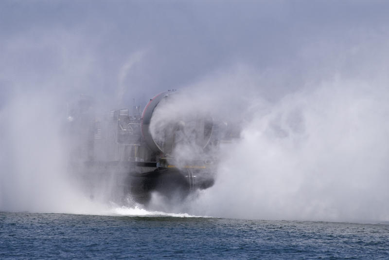 large fans propelling a navy hovercraft