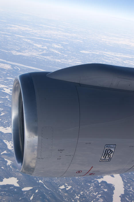 view through a plane window at a rolls royce jet engine