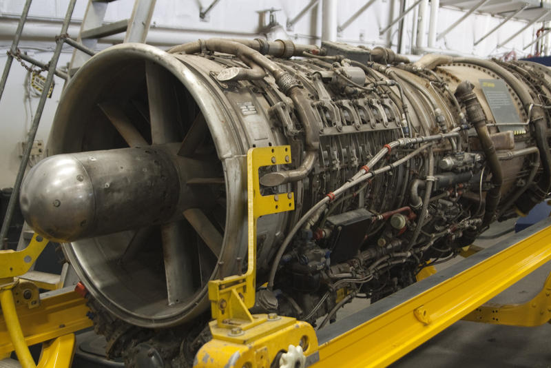 a jet engine with the cover removed revealing fuel and control lines