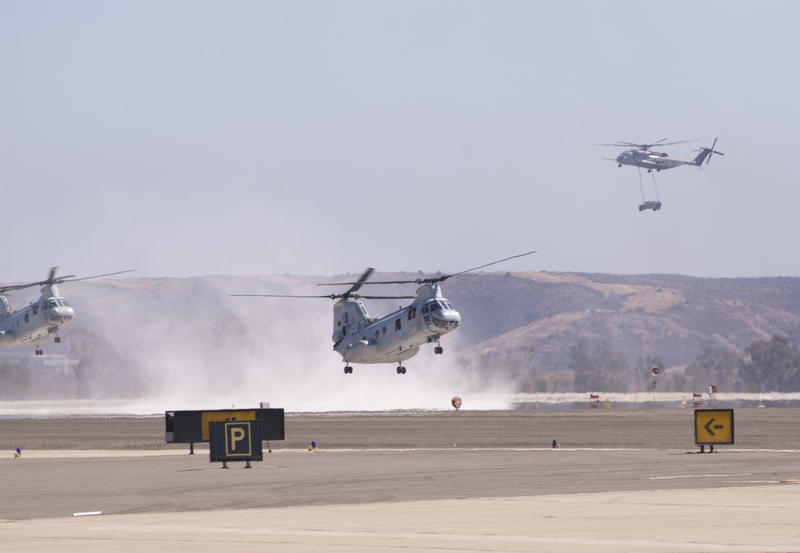 a chinook helicopter kicking up dust on landing