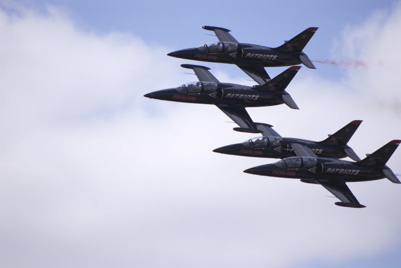 the patriots jet team in a formation flyby