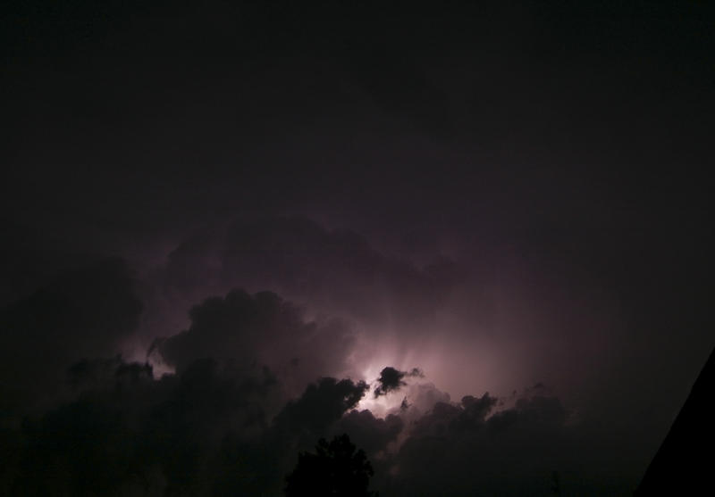 sheet lighting flashes across the clouds during a thunderstorm 
