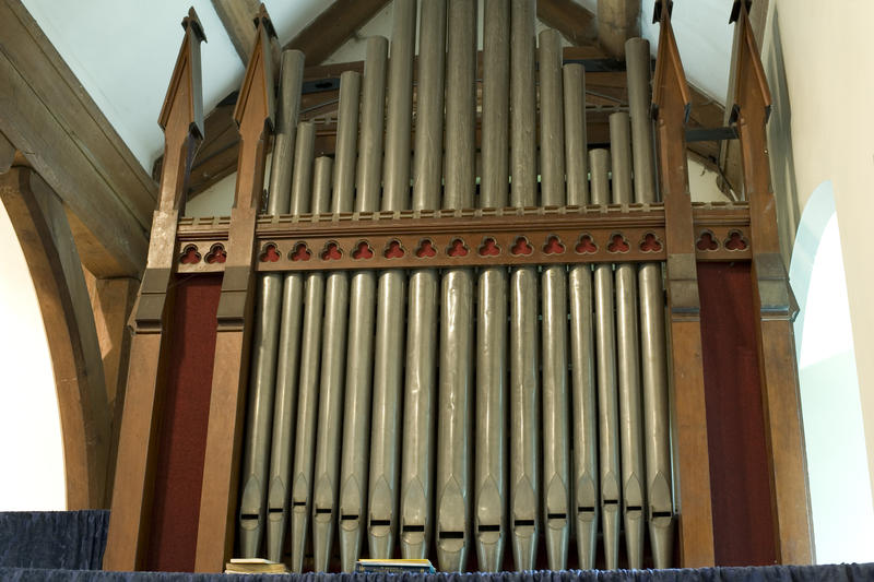 the organ pipes on the front of a small village church organ