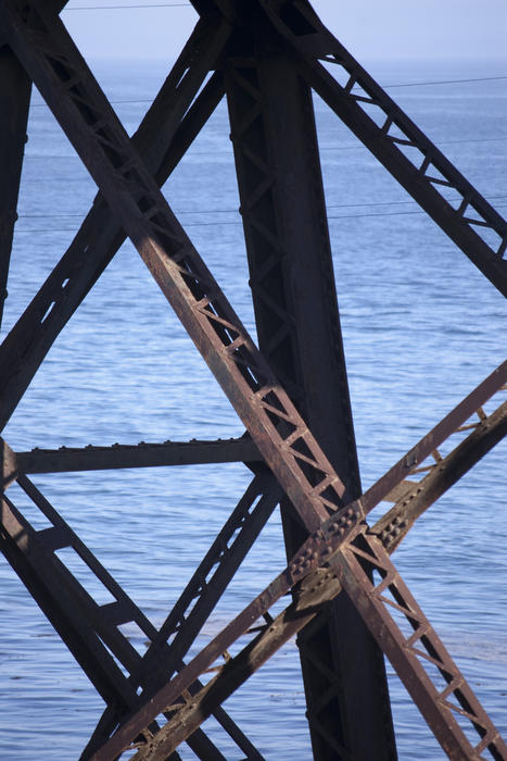 close up on the sutructure of a steel trestle railway bridge