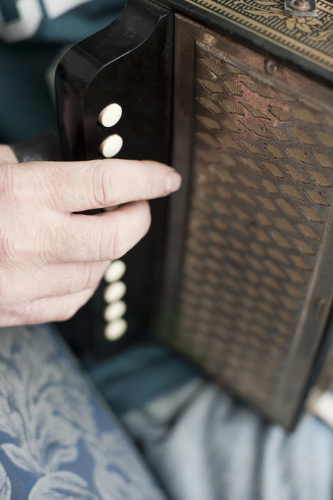 close up on a hand playnig the accordion