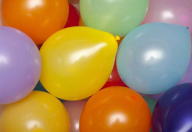 a background of various colored party baloons