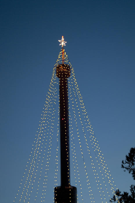 a tower decorated with streams of christmas lights ready for the holidays