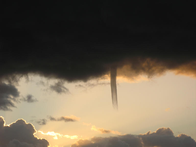 A cold air funnel cloud is like a mini tornado but is not in contact with the ground