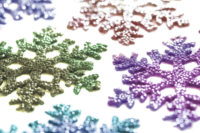 a background image of colorful snowflake shaped decorations on a white backdround