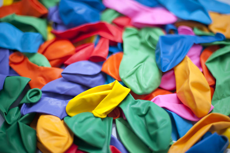 a background of assorted brightly colored party balloons