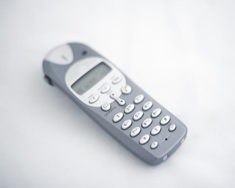 a narrow depth of field image of a cordless telephone on a white background