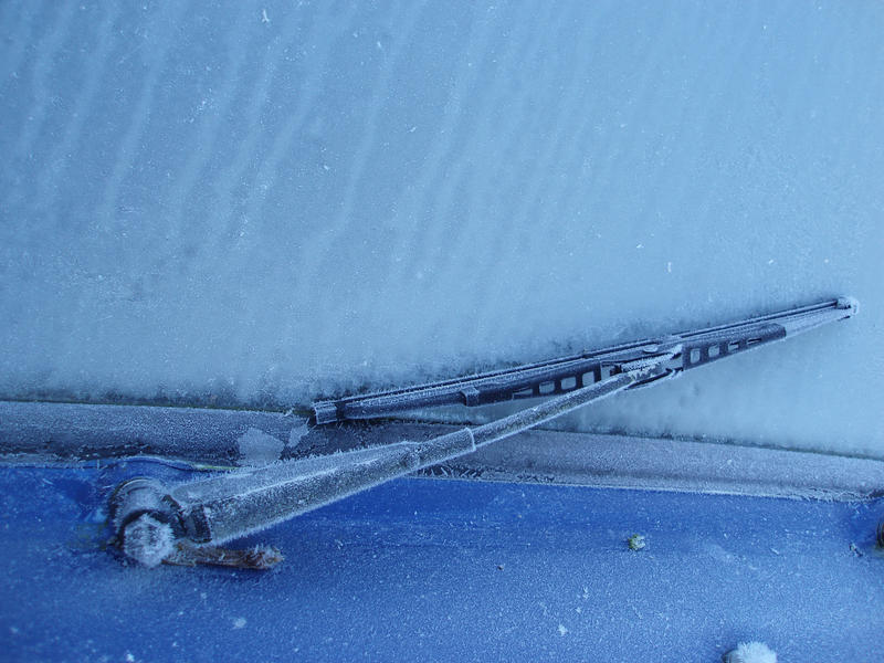 a wiper blade frozen onto the windscreen of a car