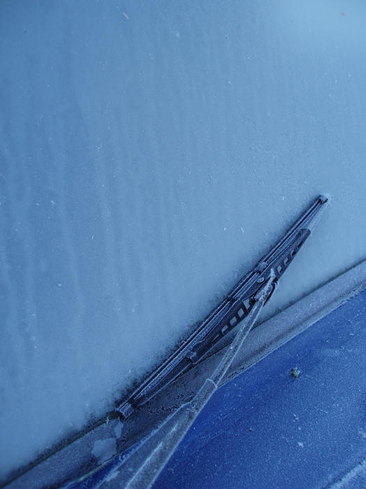 a common problem in cold climes, wipers frozen onto a car windscreen
