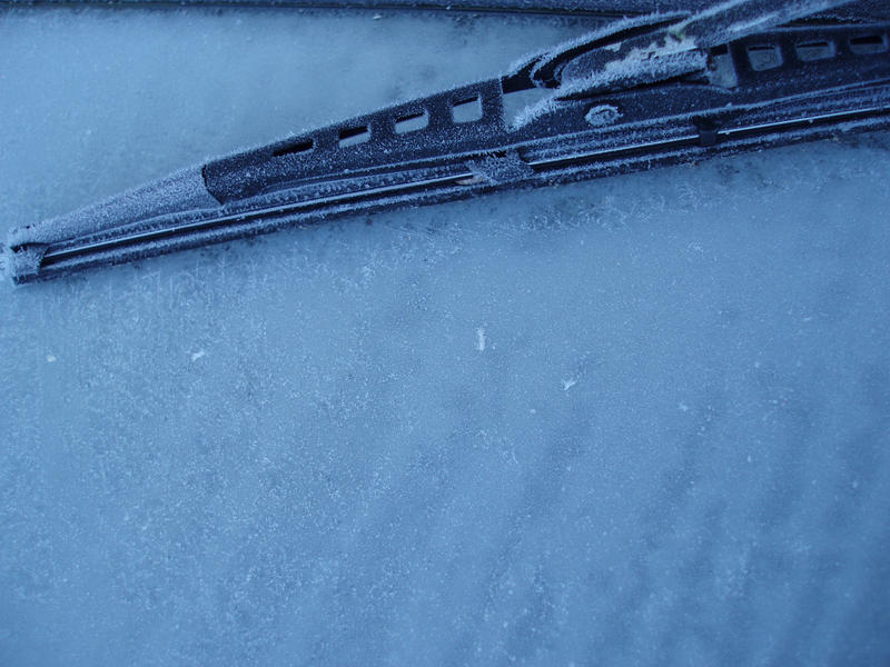 a windscreen wiper frozen onto a car windscreen