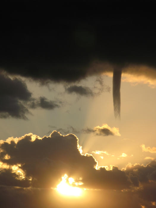 A cold air funnel cloud, like a mini tornado but not in contact with the ground