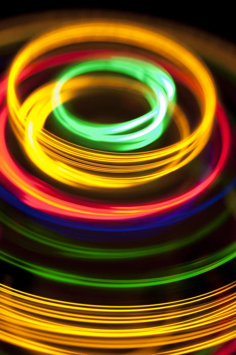 colourful glowing rings of light on a black backdrop