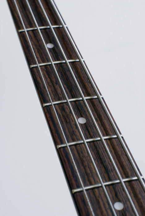 a bass guitar neck isolated on a white background