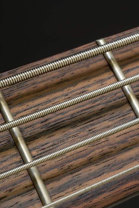 close up on the strings on a bass guitar