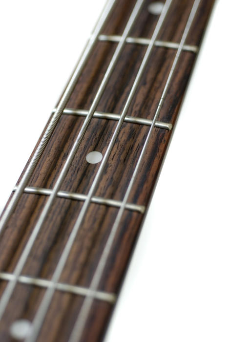 close up on the neck of a base guitar
